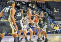  ?? STAFF PHOTO BY TIM BARBER ?? UTC forward Abbey Cornelius is smothered by Purdue’s Ae’rianna Harris (32), Tamara Farquhar (25) and Jenelle Grant (22) in the paint early in Thursday’s game at McKenzie Arena. Purdue won 66-34 as UTC shot just 21.9% from the field.