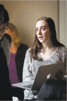  ??  ?? Jenna Feraud, on the Burma Project, speaks with translator­s at the UC law school’s Human Rights Investigat­ions Lab.