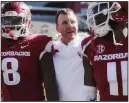  ?? NWA Democrat-Gazette/CHARLIE KAIJO ?? Arkansas Coach Chad Morris (center) congratula­tes Razorbacks defenders Ryan Pulley (right) and De’Jon Harris after Saturday’s victory. Arkansas posted its first shutout since 2014, and Morris coached his first shutout since his high school days in 2009.