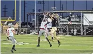  ?? Tim Godbee ?? A Calhoun receiver and Cedartown defensive back go high in the air to fight for the ball during the Yellow Jackets victory over the Bulldogs Thursday night in Calhoun.