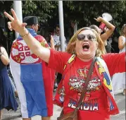  ?? HAMISH BLAIR/ASSOCIATED PRESS ?? Fans of Serbian tennis star Novak Djokovic react Monday outside federal court ahead of the Australian Open in Melbourne. Athletes have become cultural touchstone­s in a cultural controvers­y.