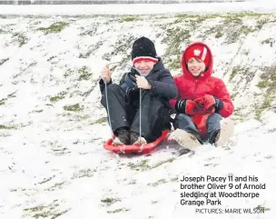  ?? PICTURES: MARIE WILSON ?? Joseph Pacey 11 and his brother Oliver 9 of Arnold sledging at Woodthorpe Grange Park