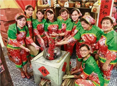  ??  ?? Picture perfect: Hakka ladies from the Federation of Hakka Associatio­ns Malaysia dressed up in traditiona­l Hakka outfits posing at the photo booth at Sunway Pyramid.