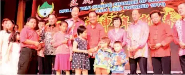  ??  ?? From second right,Yeo,Yong, Chen, Lui,Teo, Liew and Ling giving away ang pows to the children.