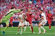  ?? MARTIN MEISSNER / POOL ?? Belgium’s goalkeeper Thibaut Courtois, left, punches the ball away during the Euro 2020 soccer championsh­ip match between Denmark and Belgium at Parken stadium in Copenhagen, Denmark, Thursday.