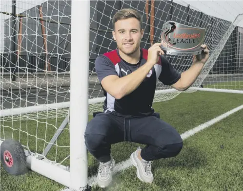  ??  ?? 0 Lewis Vaughan, who has scored 13 goals in nine matches so far, shows off his League 1 Player of the Month trophy for August.