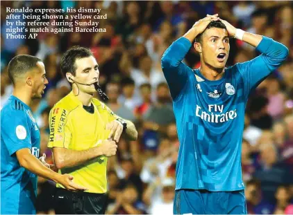  ??  ?? Ronaldo expresses his dismay after being shown a yellow card by the referee during Sunday night’s match against Barcelona Photo: AP