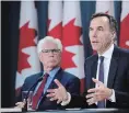  ?? SEAN KILPATRICK THE CANADIAN PRESS ?? Finance Minister Bill Morneau, right, and Natural Resources Minister James Carr speak in Ottawa on Tuesday.