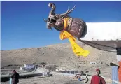  ?? ?? Buddhist monks stand atop a monastery at Komic village in Lahaul and Spiti district in the Himalayan state of Himachal Pradesh. Despite the hostile terrain, the northern state became the first in India to administer at least one Covid vaccine dose to all its adults.