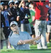  ?? John Amis Associated Press ?? TIGER WOODS KEPT his momentum with a par from the sand on the 13th hole at East Lake.