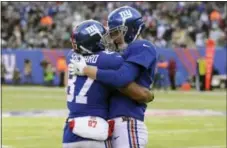  ?? BILL KOSTROUN — THE ASSOCIATED PRESS ?? New York Giants wide receiver Sterling Shepard, left, and quarterbac­k Eli Manning celebrate after they connected for a long touchdown pass during the first half Sunday against the Eagles at MetLife Stadium.