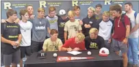  ?? Kevin Myrick ?? Teammates from the Rockmart High baseball team watch as their catcher Dylan Bailey signs with Jacksonvil­le State on May 10.