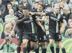  ??  ?? 0 Hibs’ John Mcginn, second left, celebrates with team-mates after scoring his second goal in last season’s 2-2 draw at Parkhead.