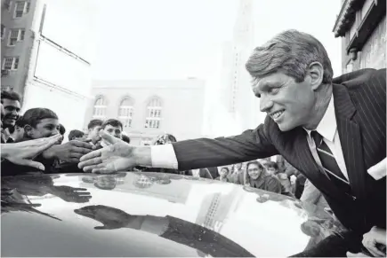  ??  ?? Sen. Robert F. Kennedy greets supporters in Fort Greene, N.Y., in December 1967. Several months later the presidenti­al candidate would be dead, felled by an assassin’s bullet in Los Angeles. JP LAFFONT/SYGMA/CORBIS