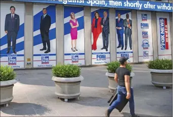  ?? AP PHOTO/TED SHAFFREY, FILE ?? Images of Fox News personalit­ies, from left, Tucker Carlson, Sean Hannity, Laura Ingraham, Maria Bartiromo, Stuart Varney, Neil Cavuto and Charles Payne appear outside News Corporatio­n headquarte­rs in New York on July 31, 2021.