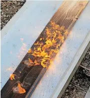  ??  ?? Wood burns as Andy Zeeck demonstrat­es the Japanese wood-burning technique shou sugi ban.