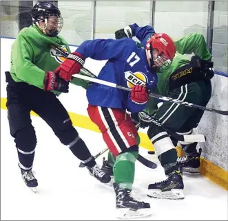  ?? DAVID CROMPTON/Penticton Herald ?? Porter Trevelyan (blue jersey) of Team Stecher battles with a pair of Team Reilly players during the Vees Bantam Exposure Showcase Sunday at the OHS Training Centre rink. Team Reilly won the game.