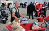  ?? ?? Jim Barber from Swift Current makes a donation of toys in support of the Toy Run, Sept. 17.