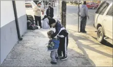  ?? ASSOCIATED PRESS ?? HONDURAN BOYS WHOSE FAMILY wants to seek asylum in the U.S., play on the sidewalk in Tijuana, Mexico, on Feb. 8.