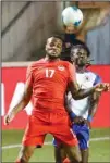  ??  ?? Canada’s Cyle Larin (17) goes for a header against Haiti’s Ade Ricardo (4) during the second half of a World Cup qualifying soccer match, on June 15, in Bridgeview, Ill. (AP)