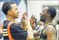  ??  ?? By Charles Rex Arbogast, AP Mcdouble: UCLA recruits Kyle Anderson, left, and Shabazz Muhammad talk at the Mcdonald’s All-american Game dunk contest.