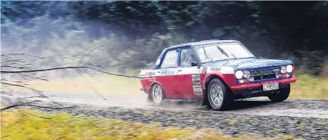  ??  ?? In his element . . . Otago Rally competitor John Spencer gets in a practice drive in his Datsun at Whare Flat yesterday.