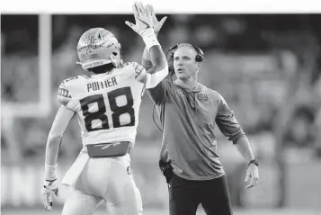  ?? JOSHUA BESSEX AP ?? Florida State head coach Mike Norvell, here high-fiving wide receiver Kentron Poitier during their game against Syracuse on Nov. 12, is looking to beat archrivals Miami and Florida in the same season for the first time since 2016.