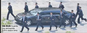  ??  ?? ON RUN Guards jog alongside Kim’s black limo