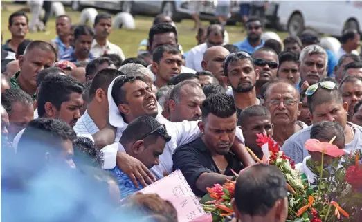  ?? Photo: Waisea Nasokia ?? Salvin Singh, helped by family members at the Votualevu Crematoriu­m in Nadi on August 31, 2019.