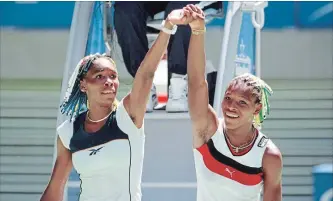  ?? ASSOCIATED PRESS FILE PHOTO ?? Venus Williams, left, and sister Serena. raise their arms after their centre-court match at the Australian Open Tennis Championsh­ips in 1998. Only they themselves predicted their longevity.
