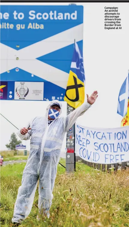  ??  ?? Campaign: An activist attempts to discourage drivers from crossing the Border from England at A1