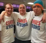  ??  ?? Mike Manzer, Larry Scott, and Matt Scott display their Cohoes Strong shirts while taking a break from bowling.