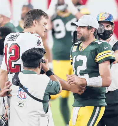  ?? MARK LOMOGLIO/AP ?? Future Hall of Fame QBs Tom Brady, left, and Aaron Rodgers will face off for just the fourth time Sunday.