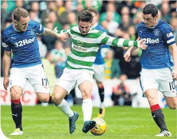  ??  ?? Celtic’s Patrick Roberts holds off Gers’ pair Lee Hodson and Graham Dorrans at Ibrox last month