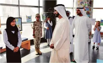  ?? WAM ?? Shaikh Mohammad meeting a group of pupils, who shared their views about the National Happiness and Positivity Programme and its future in the country.