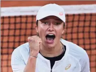  ?? Getty Images ?? Iga Swiatek celebrates after winning against Simona Halep during their women’s singles fourth-round match on Sunday at the French Open in Paris.