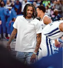  ?? Brandon Dill/Associated Press ?? Ja Morant rejoined the Grizzlies on the bench for Monday’s win over the Mavericks after finishing his eight-game suspension.