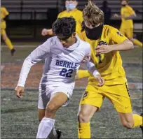  ??  ?? Berkley’s Mico Rubio, left, and Grosse Pointe South’s Emmett O’Keefe battle during Tuesday’s district semifinal contest.