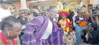  ?? ?? Pelumi Nubi in purple attire dancing with the cultural troupe at the Seme Border yesterday.