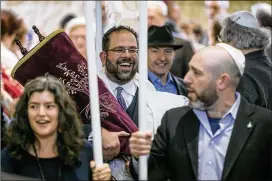  ?? JAY JANNER / AMERICAN-STATESMAN ?? Rabbi Neil Blumofe (center) carries the new Torah during its dedication service Sunday. The decision to commission a soferet to fulfill the 613th mitzvah was a deliberate one for Congregati­on Agudas Achim. Blumofe said it was important to exemplify the...