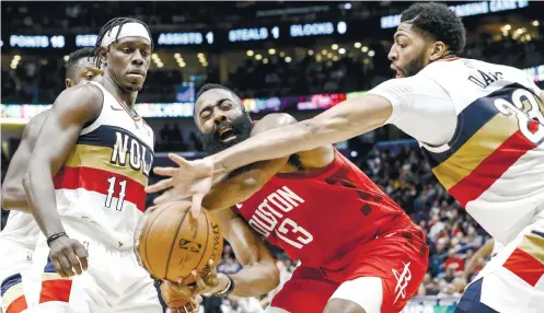  ?? AP FOTO ?? MVP. Reigning MVP James Harden (center) is being hounded by New Orleans Pelicans guard Jrue Holiday and forward Anthony Davis in the second half of a 108104 win by the Houston Rockets. SPURS 122, CLIPPERS 111