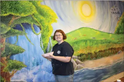  ??  ?? Lily Chesnut a recent Coosa High School grad, has spent the summer painting this beautiful mural at Harbor House. The vibrant, colorful scene will bring light and warmth to the children Harbor House Child Advocacy Center serves.