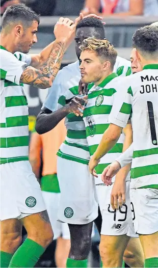  ?? Picture: AP. ?? James Forrest, centre, is congratula­ted by team-mates after scoring Celtic’s opener in Stockholm.