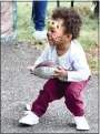  ?? JESI YOST - FOR MEDIANEWS GROUP ?? Jamaree Gore, 2, tries a football toss at the Community Festival.