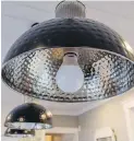  ??  ?? Above: Hanging lamps above the kitchen island are made of stainless steel salad bowls.
