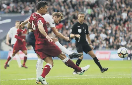  ??  ?? Harry Kane gets the better of Dejan Lovren to fire home Spurs’ first goal in yesterday’s Wembley demolition of Liverpool.