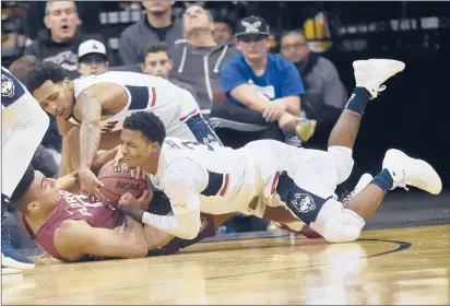  ?? BRAD HORRIGAN/HARTFORD COURANT ?? UConn guards Alterique Gilbert, right, and Jalen Adams battle Florida State guard Anthony Polite for a loose ball in the Never Forget Tribute Classic at the Prudential Center in Newark, N.J., on Saturday night.