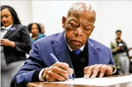  ?? BOB ANDRES / ROBERT.ANDRES@AJC.COM ?? U.S. Rep. John Lewis signed paperwork in March to qualify for reelection to his District 5 seat. The Democratic Party has nominated state Sen. Nikema Williams to replace his name on the November ballot for a full term.