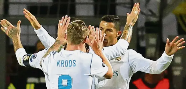  ??  ?? Proving to be a
handful: Cristiano Ronaldo celebratin­g with teammates after scoring Real Madrid’s third goal against Borussia Dortmund in the Champions League Group H clash in Dortmund on Tuesday. Real won 3-1. — AP