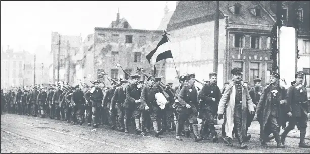  ??  ?? German soldiers march back into Germany after crossing the Rhine at Cologne following the World War One Armistice 1918 Photo Daily Mirror.